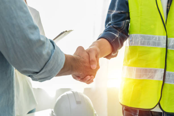 istockphoto-1321891103-612x612 Contractor. construction worker team hands shaking after plan project contract on workplace desk in meeting room office at construction site, contractor, engineering, partnership, construction concept