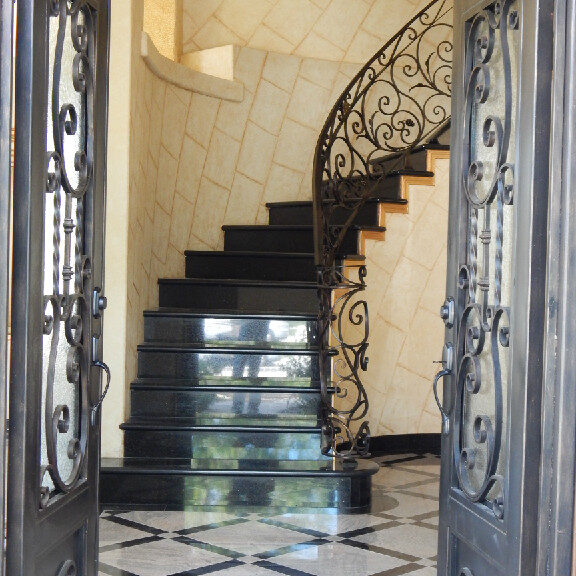 A staircase with black and white tile in the center.