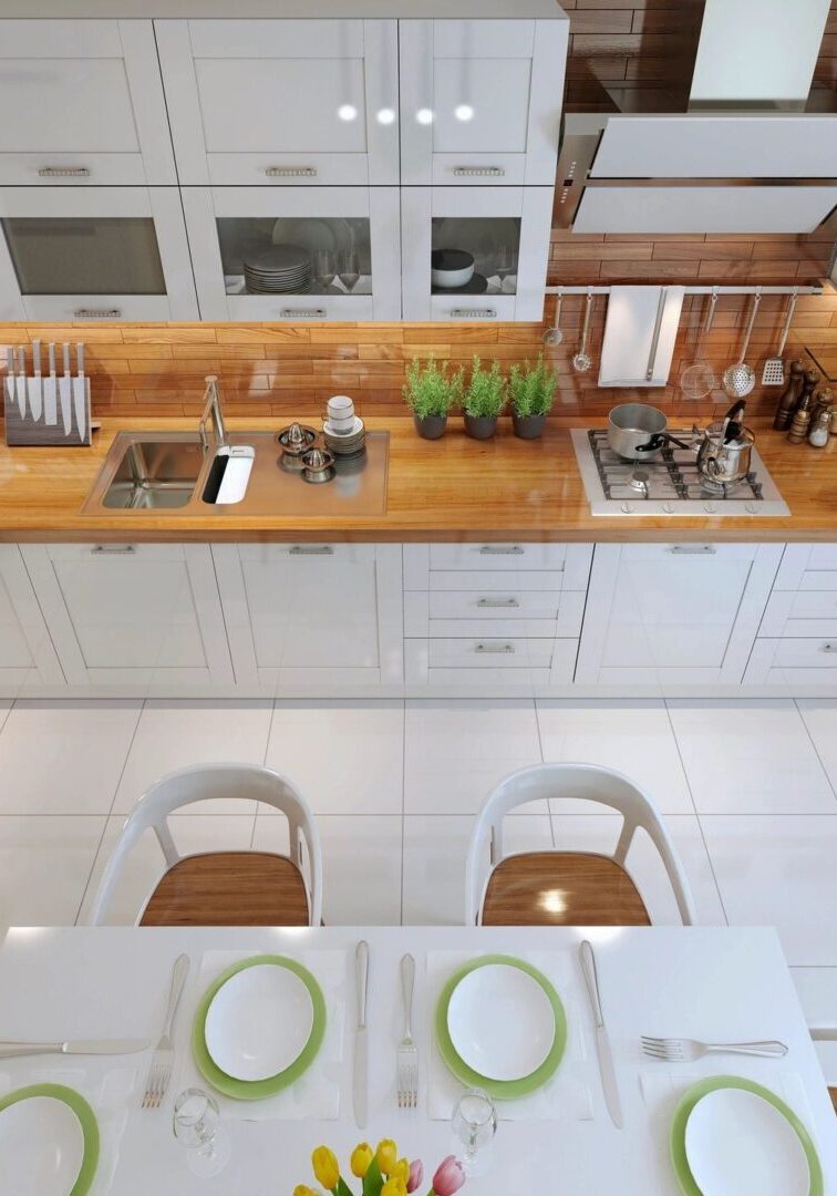 A kitchen with white cabinets and green plates